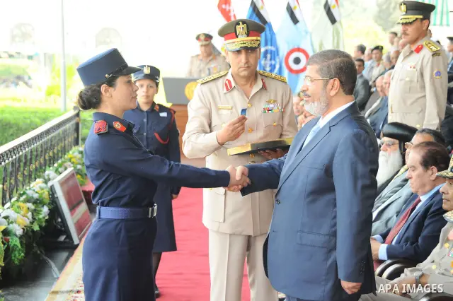 Egyptian President Mohamed Morsi honoring a military cadet during a medal ceremony for graduates at the Egyptian Military Academy in Cairo July 17, 2012. Fadi Fares / Egyptian Presidency