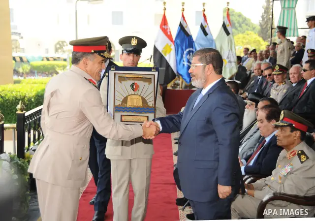 Egyptian President Mohamed Morsi honoring a military cadet during a medal ceremony for graduates at the Egyptian Military Academy in Cairo July 17, 2012. Fadi Fares / Egyptian Presidency