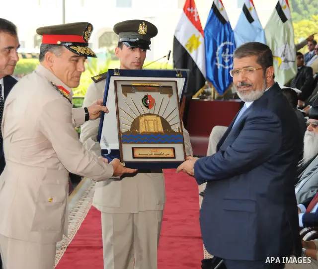 Egyptian President Mohamed Morsi honoring a military cadet during a medal ceremony for graduates at the Egyptian Military Academy in Cairo July 17, 2012. Fadi Fares / Egyptian Presidency