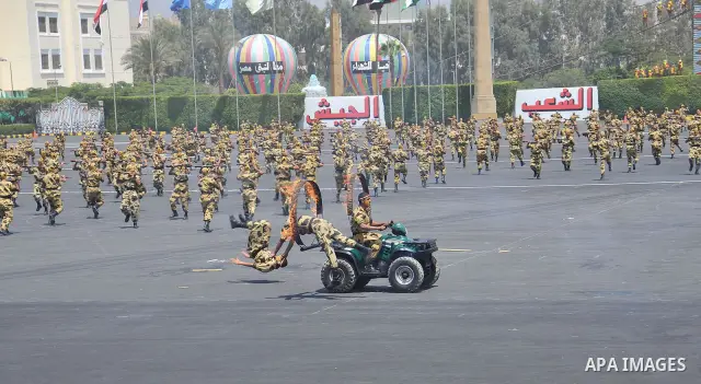 Egyptian troops demonstrate their skills at a graduation ceremony attended by President Mohammed Morsi, unseen, in Cairo, Egypt, Tuesday, July 17, 2012. Egypt's President Mohammed Morsi hailed the Egyptian army and its c...
