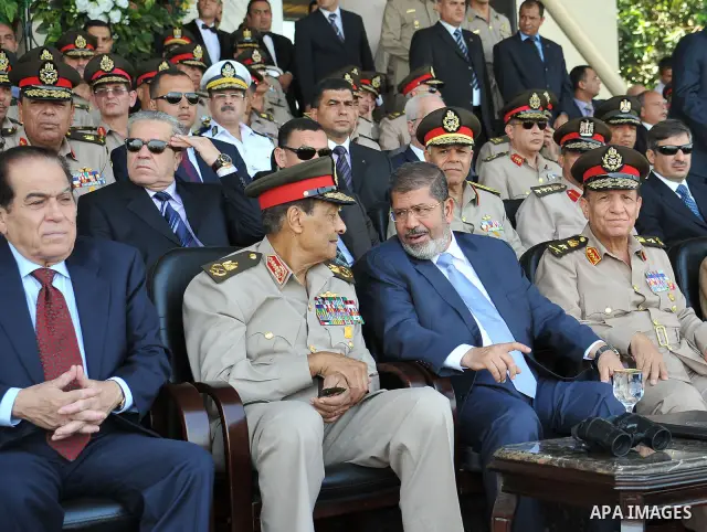 Egypt's Islamist President Mohamed Mursi (R) and Egyptian Field Marshal Hussein Tantawi speak as soldiers perform during a medal ceremony for graduates at the Egyptian Military Academy in Cairo July 17, 2012. Sherif Abd...