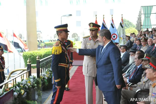 Egyptian President Mohamed Morsi honoring a military cadet during a medal ceremony for graduates at the Egyptian Military Academy in Cairo July 17, 2012. Sherif Abd Monam / Egyptian Presidency