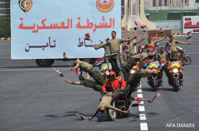 Egyptian troops demonstrate their skills at a graduation ceremony attended by President Mohammed Morsi, unseen, in Cairo, Egypt, Tuesday, July 17, 2012. Egypt's President Mohammed Morsi hailed the Egyptian army and its c...