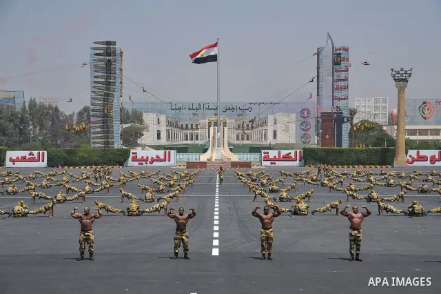 Egyptian troops demonstrate their skills at a graduation ceremony attended by President Mohammed Morsi, unseen, in Cairo, Egypt, Tuesday, July 17, 2012. Egypt's President Mohammed Morsi hailed the Egyptian army and its c...
