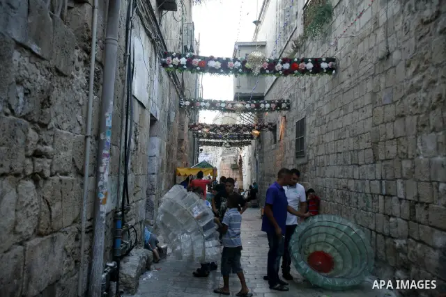 Palestinians hang up decorations before the Muslim holy month of Ramadan at a popular market in the old city of Jerusalem on July 17, 2012. The Muslim holy month of Ramadan begins Saturday 21 July , is traditionally dete...