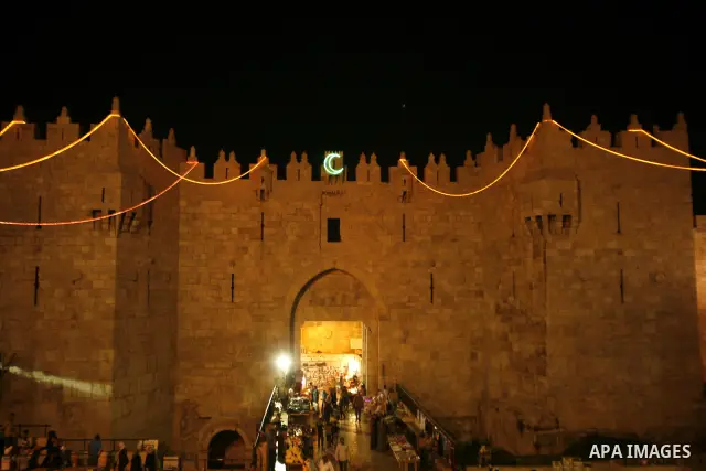 Palestinians hang up decorations before the Muslim holy month of Ramadan at a popular market in the old city of Jerusalem on July 17, 2012. The Muslim holy month of Ramadan begins Saturday 21 July , is traditionally dete...