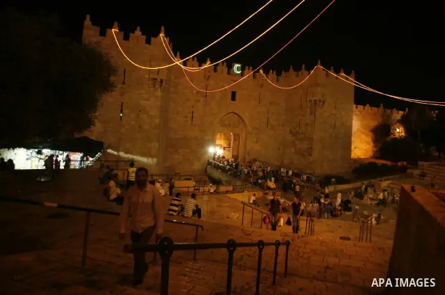 Palestinians hang up decorations before the Muslim holy month of Ramadan at a popular market in the old city of Jerusalem on July 17, 2012. The Muslim holy month of Ramadan begins Saturday 21 July , is traditionally dete...