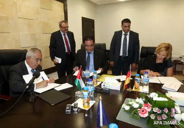 Palestinian Prime Minister Salam Fayyad signs an amity agreement with representative of donor countries, for projects in water and wastewater fields, in the West Bank city of Ramallah, on 18 July 2012. Photo by Mustafa A...