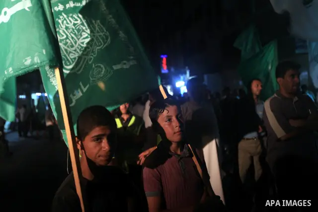 Palestinians Hamas movement supporters hold up banners during a rally in Gaza city, on 18 July 2012. Protesters demand Palestinian President Mahmoud Abbas and Egypt's President Mohamed Morsi to fix electricity crisis in...