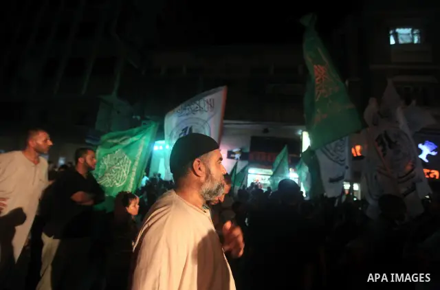 Palestinians Hamas movement supporters hold up banners during a rally in Gaza city, on 18 July 2012. Protesters demand Palestinian President Mahmoud Abbas and Egypt's President Mohamed Morsi to fix electricity crisis in...