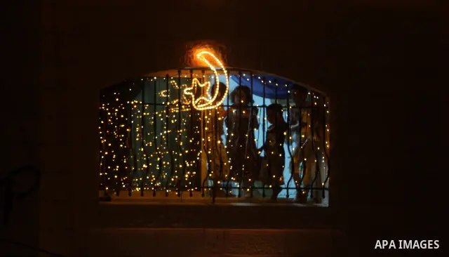 Palestinians hang up decorations before the Muslim holy month of Ramadan and write in Arabic, (Ramadan Karim) in their house in al-Bireh close to the West Bank city of Ramallah on July 18, 2012. The Muslim holy month of...
