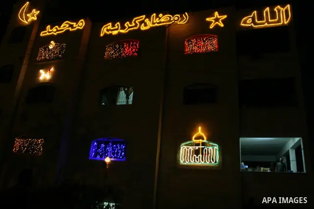 Palestinians hang up decorations before the Muslim holy month of Ramadan and write in Arabic, (Ramadan Karim) in their house in al-Bireh close to the West Bank city of Ramallah on July 18, 2012. The Muslim holy month of...