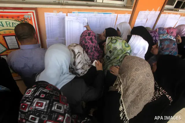 Palestinian secondary school students read a local newspaper to find their results in Gaza city on July 19, 2012. The Ministry of Education in Gaza Strip and the West Bank announced the results together. Photo by Ashraf...