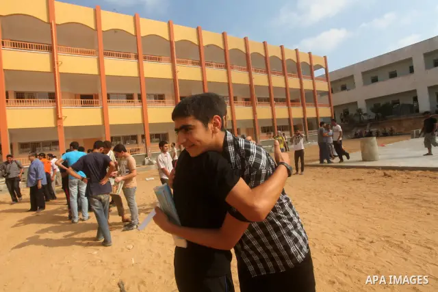 Palestinian friends Hug their secondary school students after find their results in Gaza city on July 19, 2012. The Ministry of Education in Gaza Strip and the West Bank announced the results together. Photo by Ashraf Am...