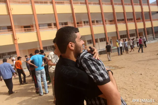 Palestinian friends Hug their secondary school students after find their results in Gaza city on July 19, 2012. The Ministry of Education in Gaza Strip and the West Bank announced the results together. Photo by Ashraf Am...