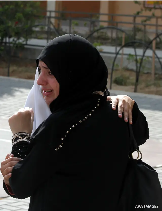 Palestinian secondary school student crying after find their results in Gaza city on July 19, 2012. The Ministry of Education in Gaza Strip and the West Bank announced the results together. Photo by Ashraf Amra