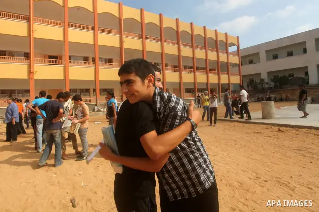 Palestinian friends Hug their secondary school students after find their results in Gaza city on July 19, 2012. The Ministry of Education in Gaza Strip and the West Bank announced the results together. Photo by Ashraf Am...
