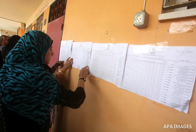Palestinian secondary school students read a local newspaper to find their results in Gaza city on July 19, 2012. The Ministry of Education in Gaza Strip and the West Bank announced the results together. Photo by Ashraf...