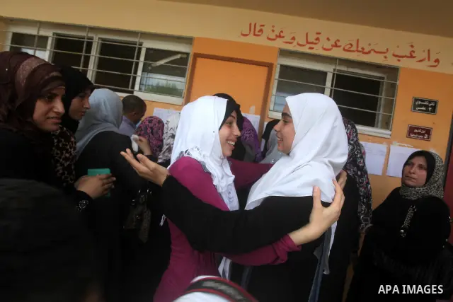 Palestinian friends Hug their secondary school students after find their results in Gaza city on July 19, 2012. The Ministry of Education in Gaza Strip and the West Bank announced the results together. Photo by Ashraf Am...