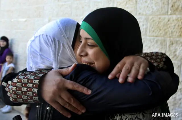 Palestinian high school students take hug after heard their results of final exams known as "Tawjihi" in the West Bank city of Nablus, on July 19, 2012. The Ministry of Education in Gaza Strip announced the final results...