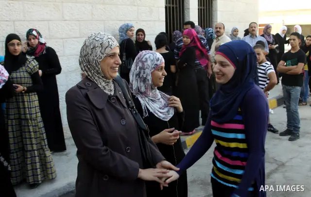Palestinian high school students take hug after heard their results of final exams known as "Tawjihi" in the West Bank city of Nablus, on July 19, 2012. The Ministry of Education in Gaza Strip announced the final results...