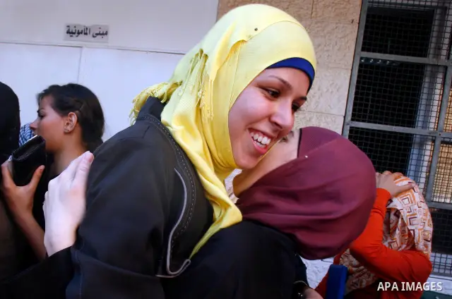 Palestinian high school students take hug after heard their results of final exams known as "Tawjihi" in Jerusalem, on July 19, 2012. The Ministry of Education in Gaza Strip announced the final results coincide with the...