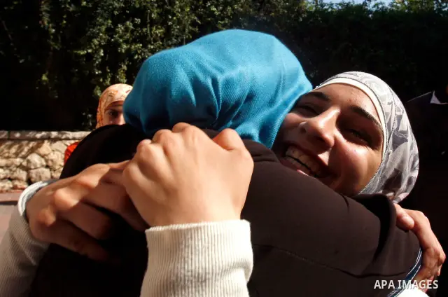 Palestinian high school students take hug after heard their results of final exams known as "Tawjihi" in Jerusalem, on July 19, 2012. The Ministry of Education in Gaza Strip announced the final results coincide with the...
