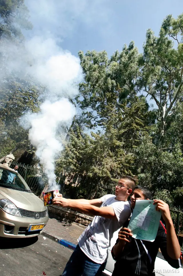 Palestinians high school students celebrate after heard their results of final exams known as "Tawjihi" in Jerusalem, on July 19, 2012. The Ministry of Education in Gaza Strip announced the final results coincide with th...