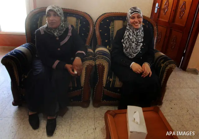 A Palestinian high school student and the sixth in section science, Muna Khalf allah celebrates with her family after heard the results of her final exams known as "Tawjihi" in Gaza city, on July 19, 2012. The Ministry o...