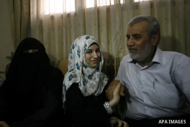 A Palestinian high school student, Nourhan Abu Obaid celebrates with her family after heard the results of her final exams known as "Tawjihi" in Rafah refugee camp southern Gaza strip, on July 19, 2012. The Ministry of E...