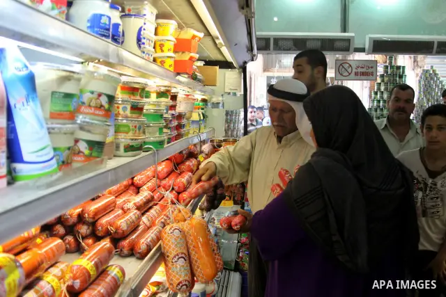 Palestinians buy foodstuff from a shop in preparation for the holy month of Ramadan in the West Bank city of Nablus, on July 19, 2012 . Islam's holy month of Ramadan will begin in two days depending on the sighting of th...