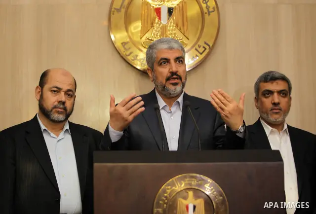 Hamas leader Khaled Meshaal (C) speaks during a news conference with Hamas delegates after their meeting with Egypt's President Mohamed Mursi at the presidential palace in Cairo July 19, 2012. Photo by Mohammed Al-Hams