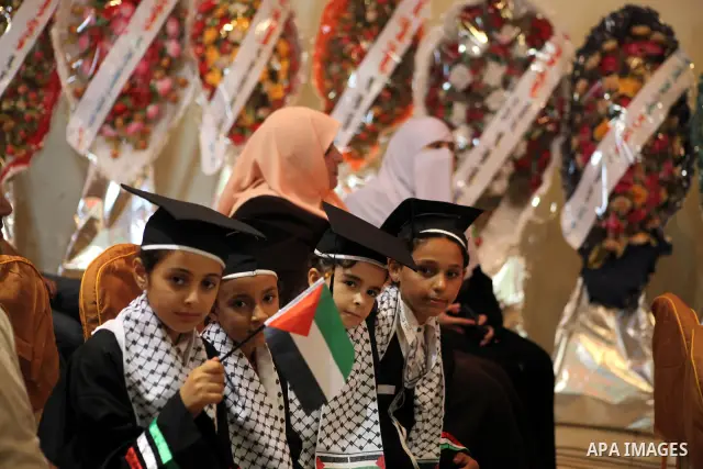 Palestinians attend the ceremony for superior high school students in Gaza city, on 19 July 2012. The Ministry of Education in Gaza Strip announced the final results of high school final exams known as ''Tawjihi'' coinci...