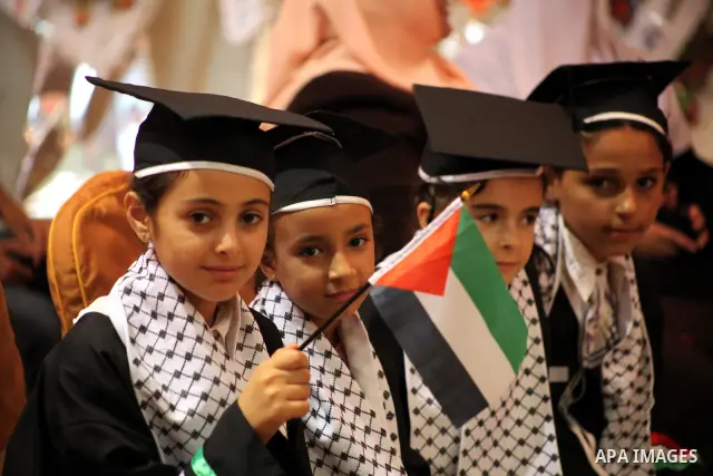 Palestinians attend the ceremony for superior high school students in Gaza city, on 19 July 2012. The Ministry of Education in Gaza Strip announced the final results of high school final exams known as ''Tawjihi'' coinci...