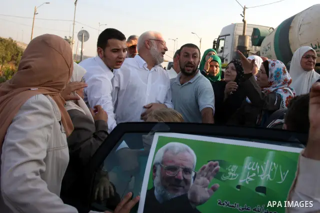 Hamas speaker of the Palestinian parliament Aziz Dweik with his family after he was released from Israeli prison, at the Beit Sira roadblock in the West Bank on 19 July 2012. The Israeli army arrested Dweik on January 19...