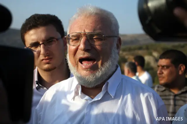 Hamas speaker of the Palestinian parliament Aziz Dweik speaks to Press after he was released from Israeli prison, at the Beit Sira roadblock in the West Bank on 19 July 2012. The Israeli army arrested Dweik on January 19...