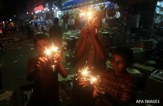 A Palestinian child Inspects toys and electric lights as the vendor displays goods in preparation for the holy month of Ramadan in the Gaza city on July 19, 2012. Ramadan is the ninth month of the Islamic calender, a mon...