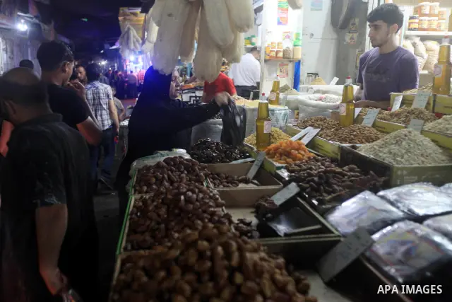Palestinians Inspect goods as the vendor displays it in preparation for the holy month of Ramadan in the Gaza city on July 19, 2012 .Ramadan is the ninth month of the Islamic calender, a month of fasting, in which partic...