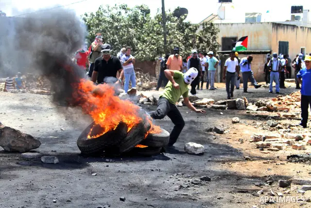 Palestinian protesters throw stones at Israeli troops during clashes as they protest against the Jewish settlement of Kdumim, near Nablus, West Bank, 20 July 2012. According to medical sources 16 Palestinians were injure...