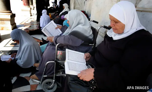 Palestinian read the Koran outside the Dome of the Rock on the compound known to Muslims as Noble Sanctuary and to Jews as Temple Mount in Jerusalem's Old City on the first Friday of the holy month of Ramadan July 20, 20...