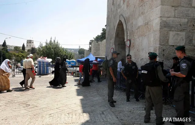 Israeli police officers stand guard as Palestinian muslim worshippers enter the compound of al-Aqsa mosque, known to Muslims as Noble Sanctuary and to Jews as Temple Mount in Jerusalem's Old City on the first Friday of t...