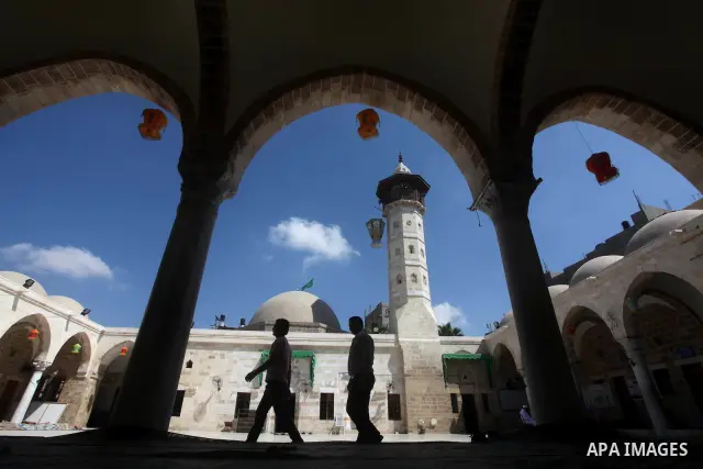Palestinian walks into a mosque in Gaza City on the second day of the month of Ramadan, on 21 July 2012. Muslims around the world refrain from eating, drinking and sexual intercourse from dawn till dusk during Ramadan, t...