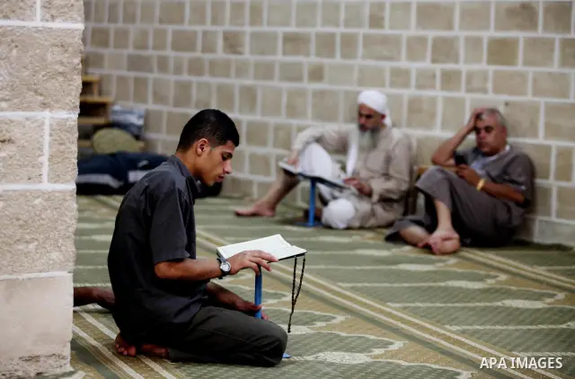 Palestinian muslims read the holy Qur'an at al-Omari mosque in Gaza city, on 21 July 2012. Muslims around the world refrain from eating, drinking and sexual intercourse from dawn till dusk during Ramadan, the holiest mon...