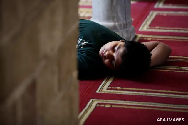 Palestinians take rest at a mosque in Gaza City on the second day of the month of Ramadan on 21 July 2012. Muslims around the world refrain from eating, drinking and sexual intercourse from dawn till dusk during Ramadan,...