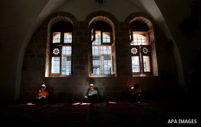 Palestinian children read the holy Qur'an at a mosque in Gaza city, on 21 July 2012. Muslims around the world refrain from eating, drinking and sexual intercourse from dawn till dusk during Ramadan, the holiest month in...