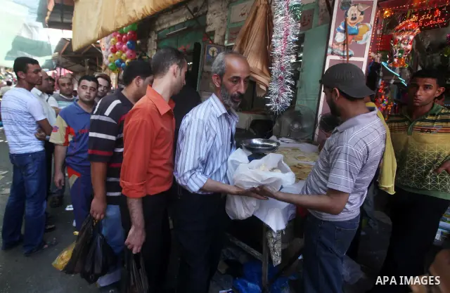 Palestinians shop at the traditional market in Gaza city on the second day of the holy month of Ramadan,on 21 July 2012. Muslims around the world abstain from eating, drinking and conducting sexual relations from dawn ti...