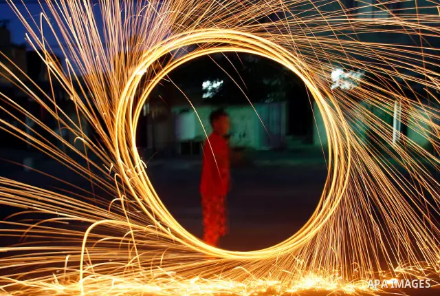 A Palestinian child lights fireworks to celebrate the second day of the Muslim Holy fasting month of Ramadan in Rafah in south of Gaza Strip on 21 July 2012. Muslims throughout the world are celebrating the fasting month...
