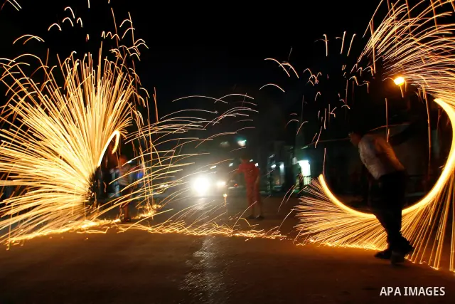 A Palestinian child lights fireworks to celebrate the second day of the Muslim Holy fasting month of Ramadan in Rafah in south of Gaza Strip on 21 July 2012. Muslims throughout the world are celebrating the fasting month...