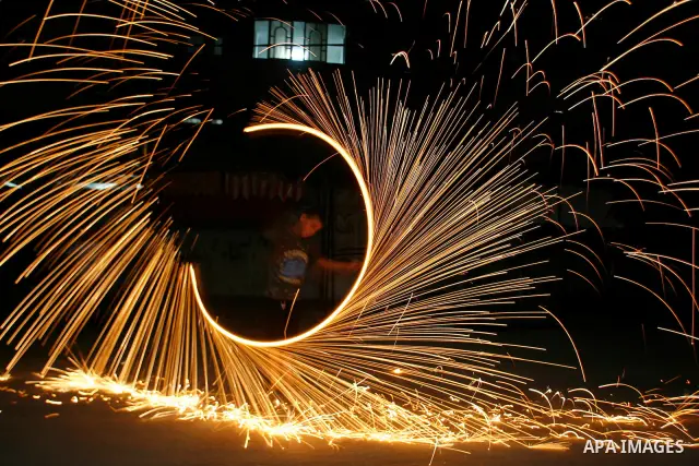 A Palestinian child lights fireworks to celebrate the second day of the Muslim Holy fasting month of Ramadan in Rafah in south of Gaza Strip on 21 July 2012. Muslims throughout the world are celebrating the fasting month...