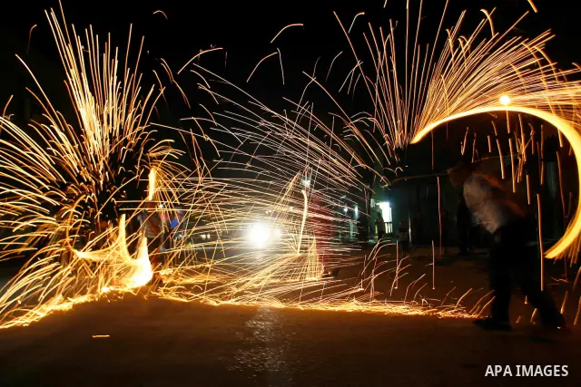 A Palestinian child lights fireworks to celebrate the second day of the Muslim Holy fasting month of Ramadan in Rafah in south of Gaza Strip on 21 July 2012. Muslims throughout the world are celebrating the fasting month...